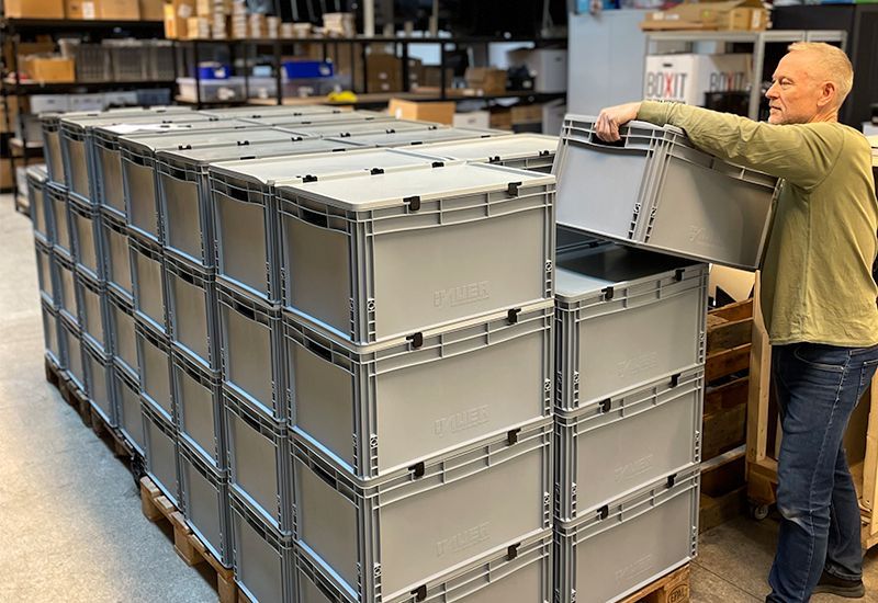 billede af bærbare computere der bliver pakket i kasser